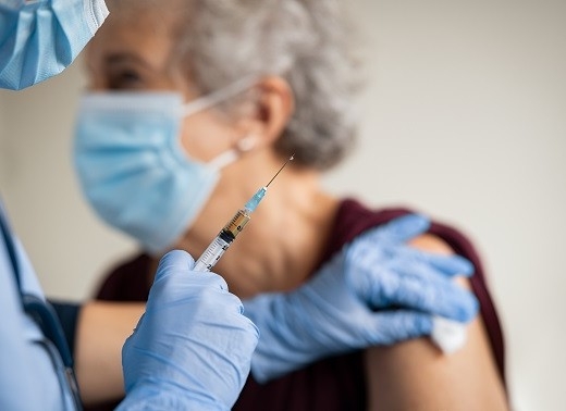 An older adult receives a vaccine